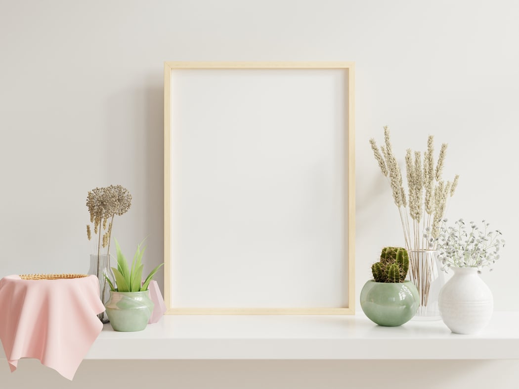 Wooden Frame on White Shelf with Plants